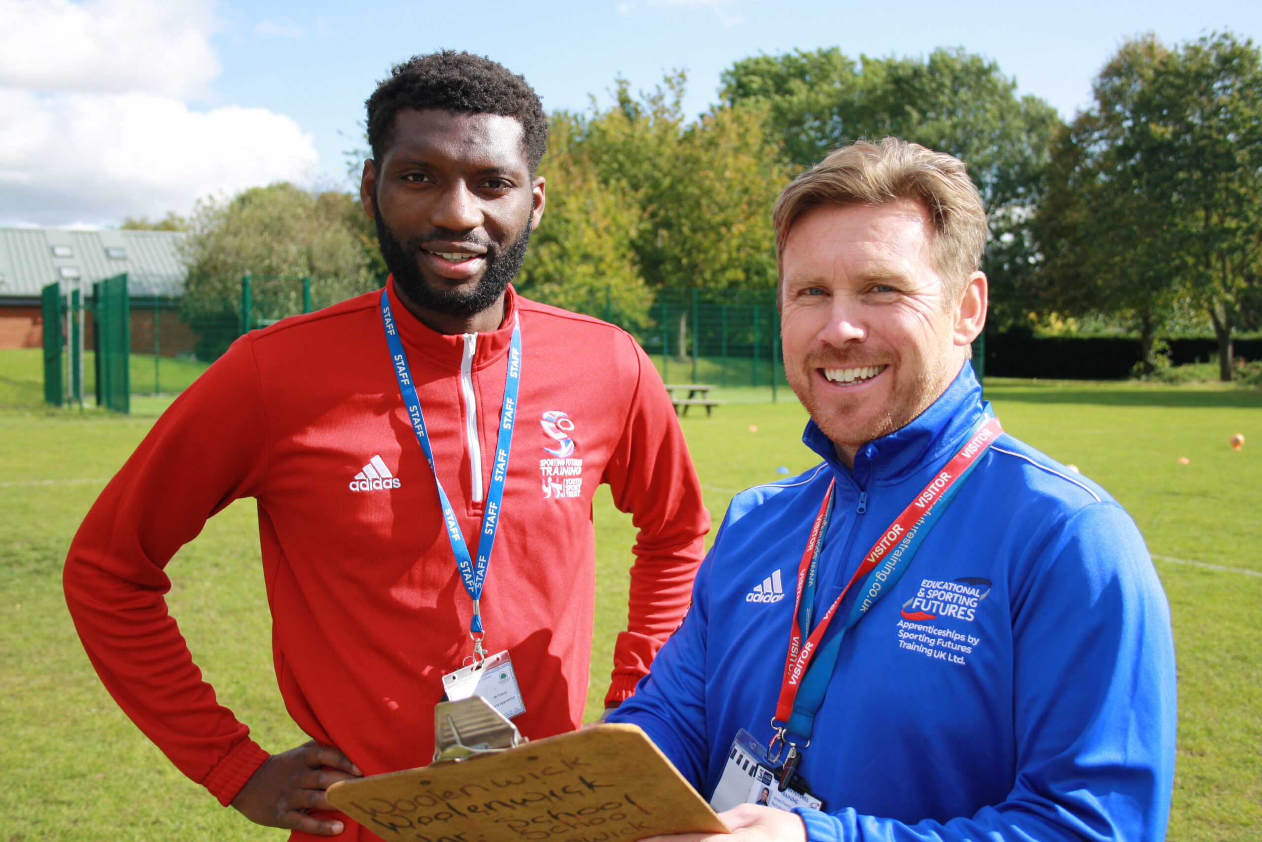 Image of a pair of ESF Trainers smiling in a field