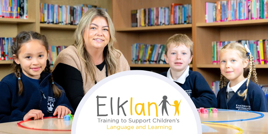 A teaching assistant helping pupils with language and literacy skills