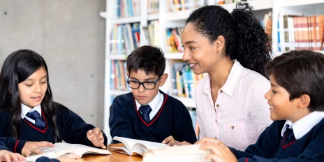A teaching assistant helps with a literacy lesson
