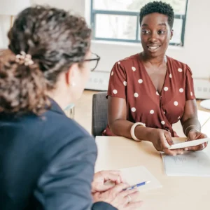 Two senior school leaders discussing work at a table