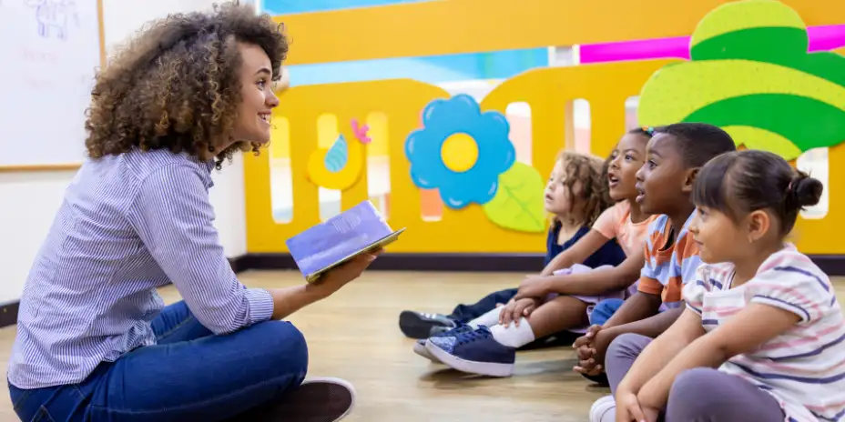 a nursery practitioner reads to preschoolers