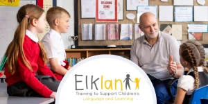 A teaching assistant reading a book and engaging with children with speech, language and communication needs